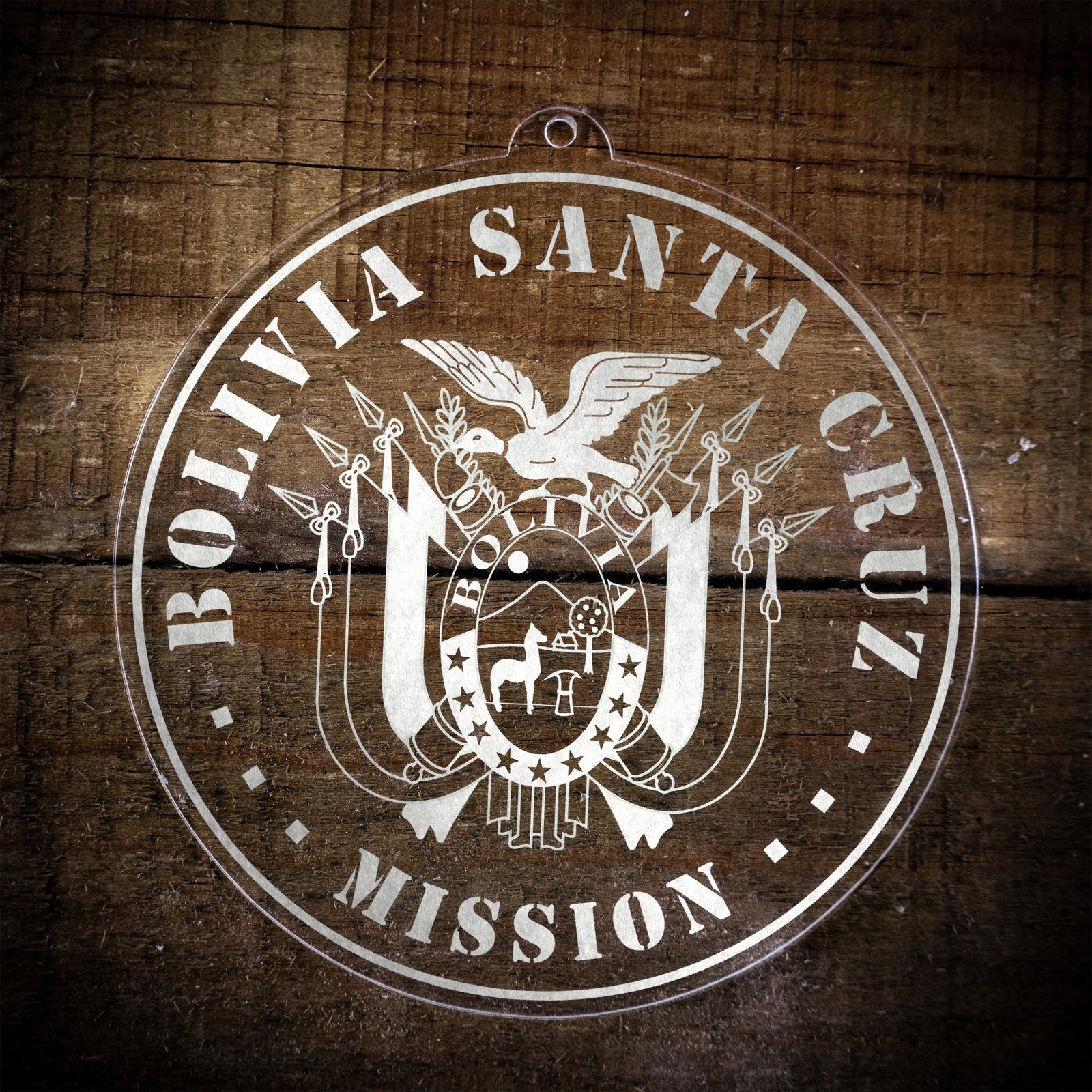 LDS Bolivia Santa Cruz Mission Christmas Ornament laying on a Wooden Background