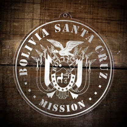 LDS Bolivia Santa Cruz Mission Christmas Ornament laying on a Wooden Background