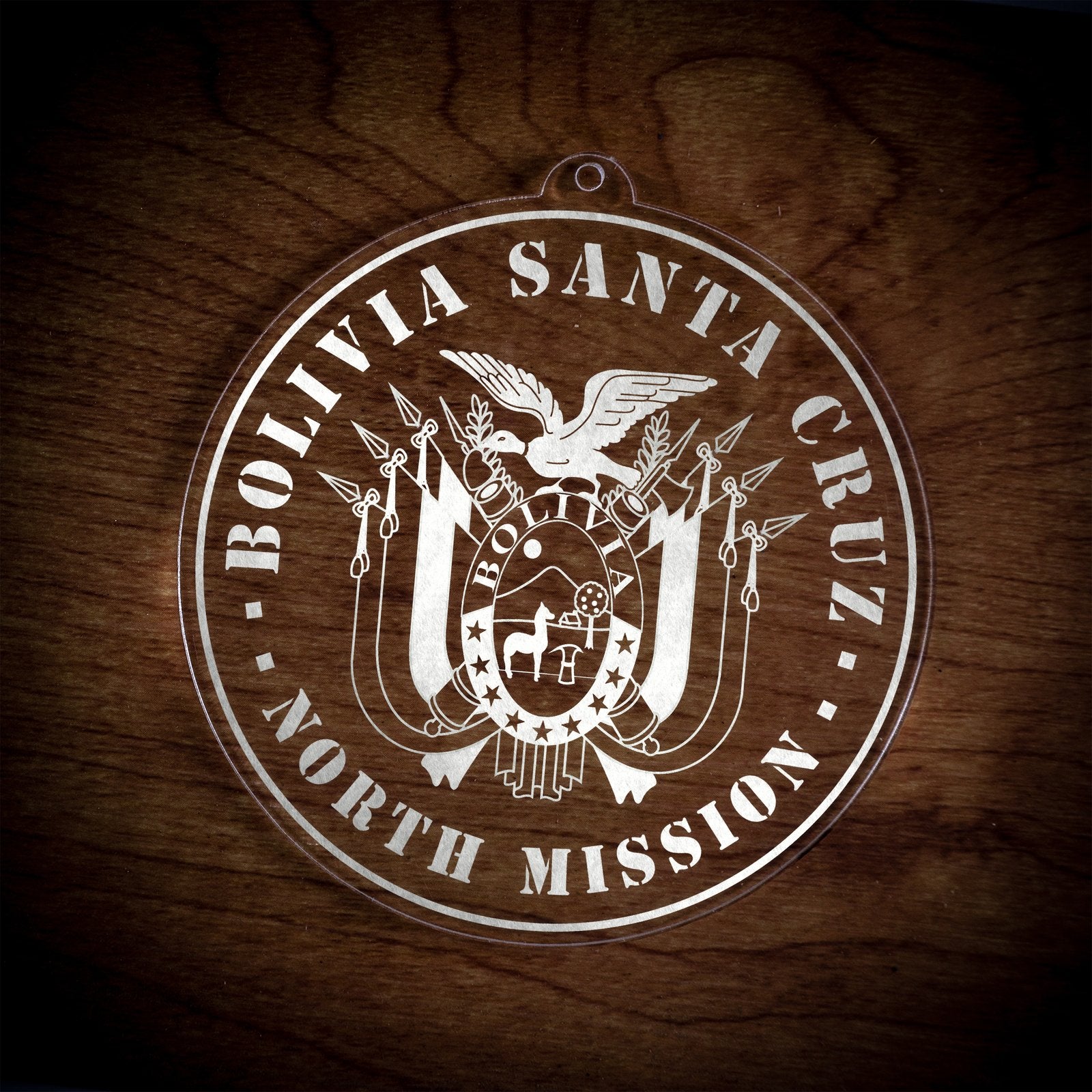 LDS Bolivia Santa Cruz North Mission Christmas Ornament laying on a Wooden Background