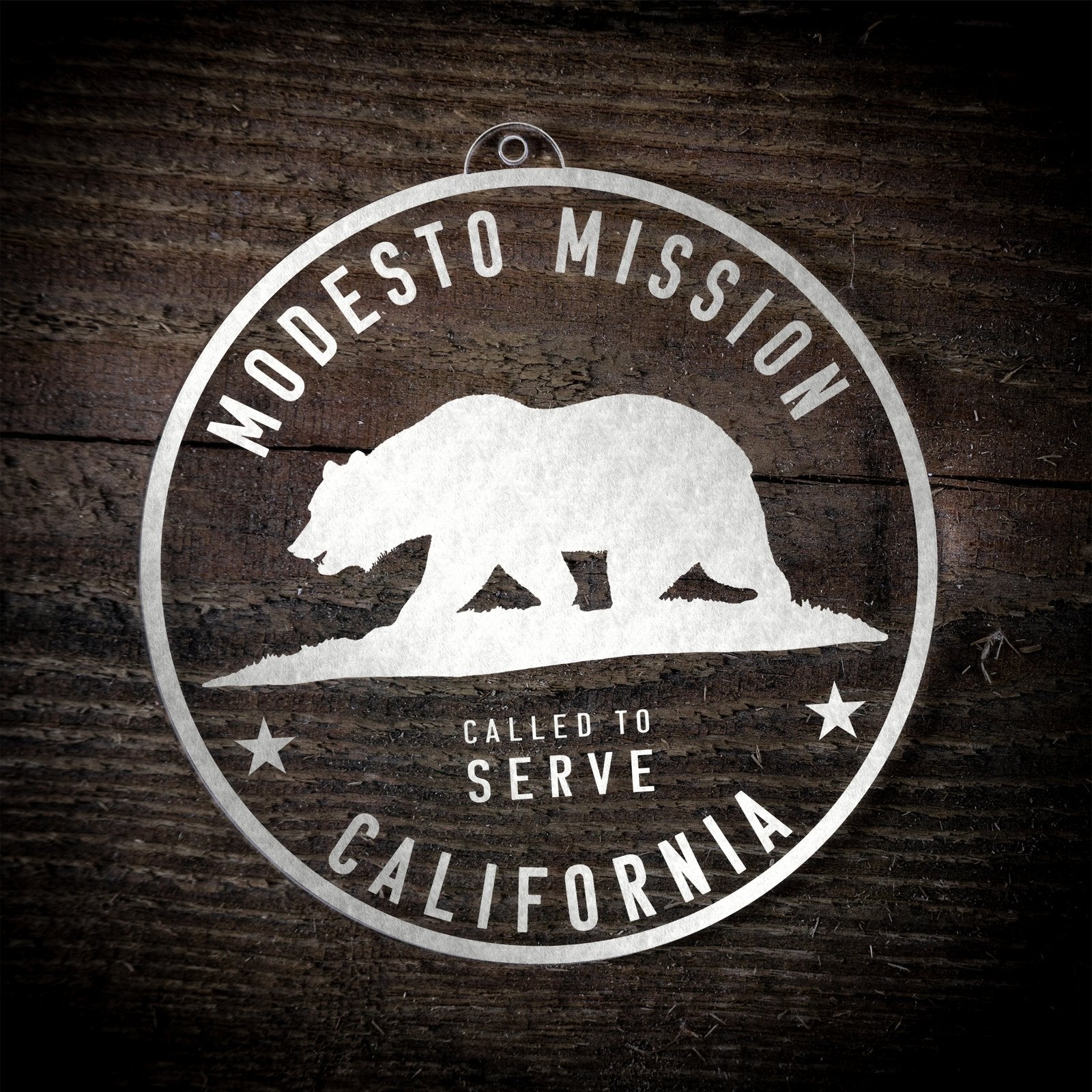 LDS California Modesto Mission Christmas Ornament laying on a Wooden Background