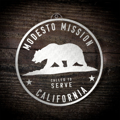 LDS California Modesto Mission Christmas Ornament laying on a Wooden Background