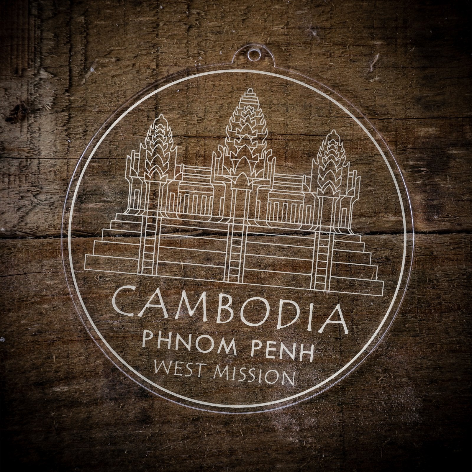 LDS Cambodia Phnom Penh West Mission Christmas Ornament laying on a Wooden Background