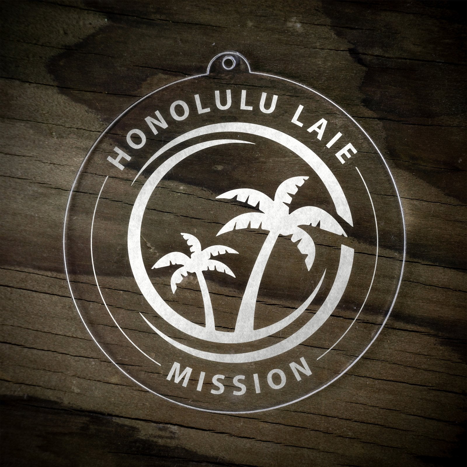 LDS Hawaii Laie Mission Christmas Ornament laying on a Wooden Background