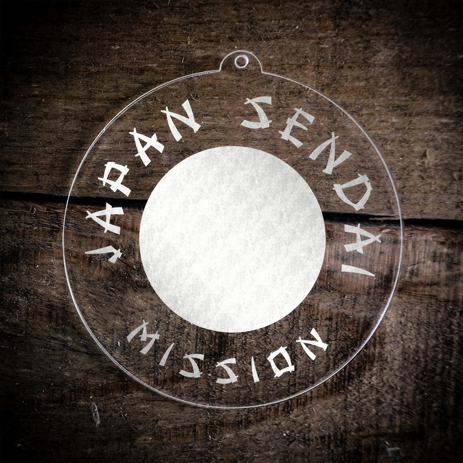 LDS Japan Sendai Mission Christmas Ornament laying on a Wooden Background