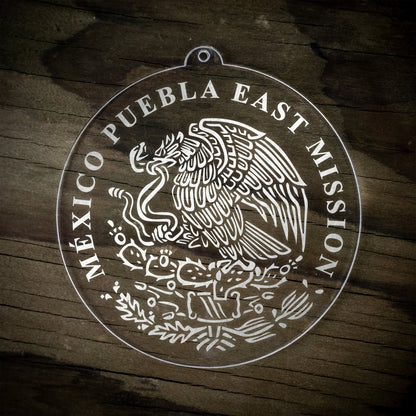 LDS Mexico Puebla East Mission Christmas Ornament laying on a Wooden Background