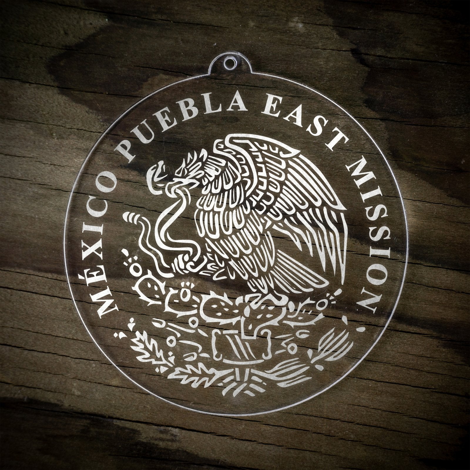 LDS Mexico Puebla East Mission Christmas Ornament laying on a Wooden Background