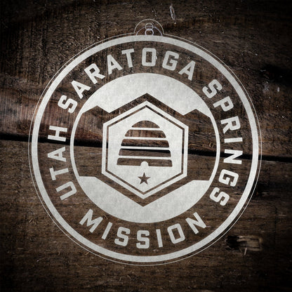 LDS Utah Saratoga Springs Mission Christmas Ornament laying on a Wooden Background